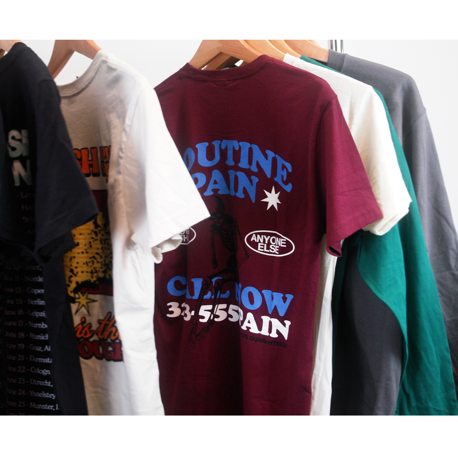 image of the front of a maroon tee shirt on a white background. front of tee has a small chest print on the right. stacked in blue says spanish love songs and below in white says results guaranteed!